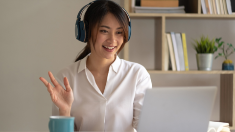 A student waves at a screen
